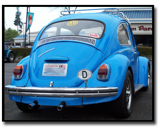 Blue classic Volkswagen Beetle from behind