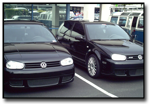 Black Volkswagen hatchback vehicles parked